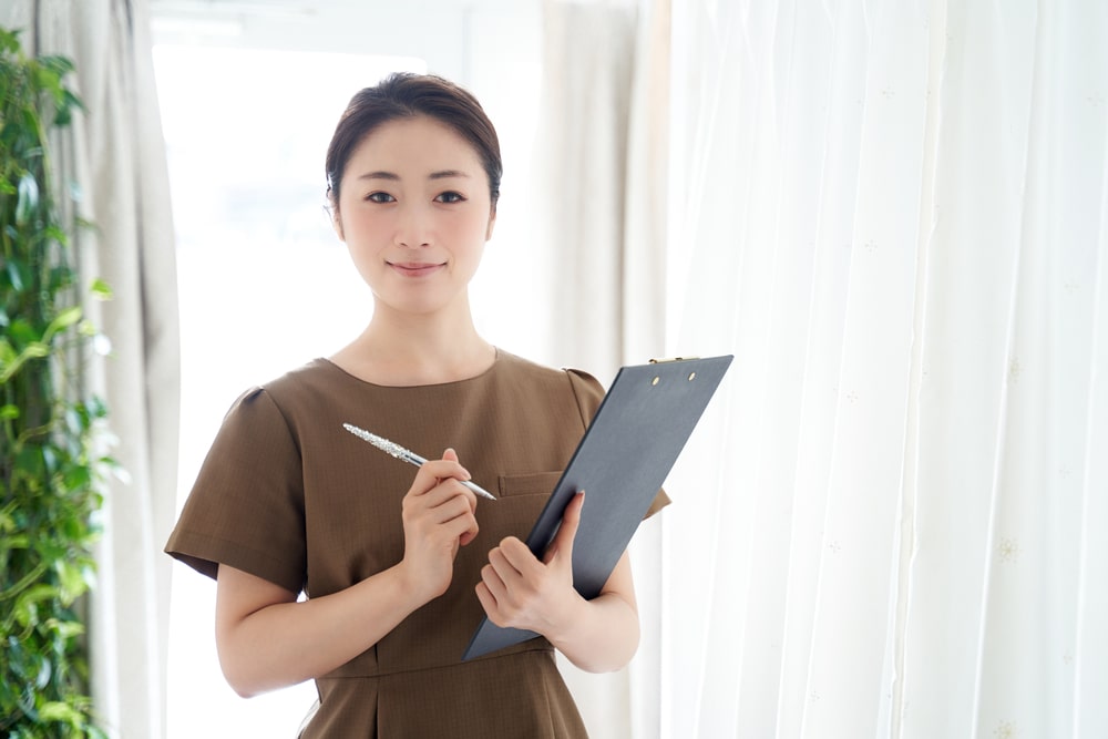 Woman in an esthetics office holding a clipboard